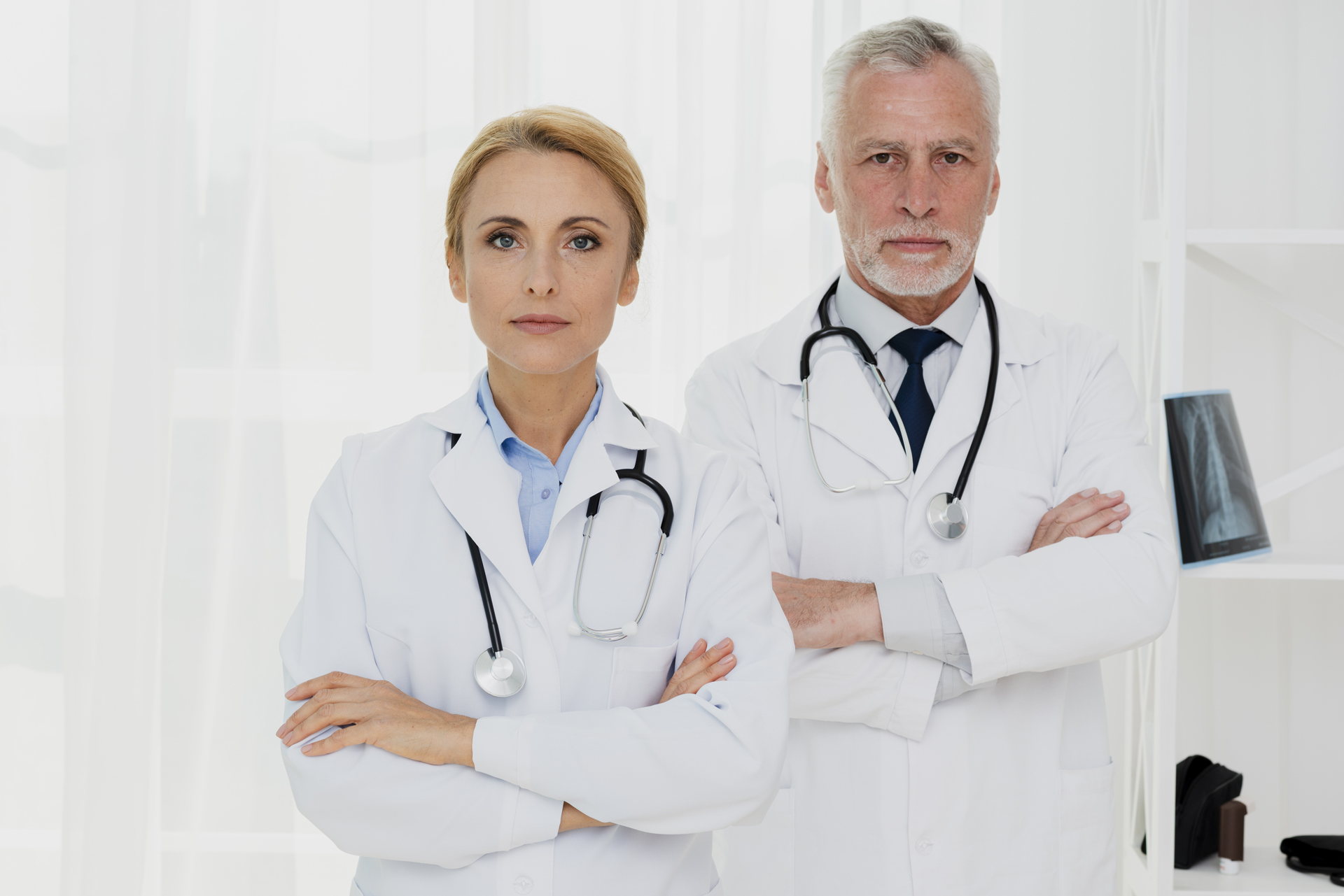 doctors-with-crossed-hands-looking-camera doctors-with-crossed-hands-looking-camera