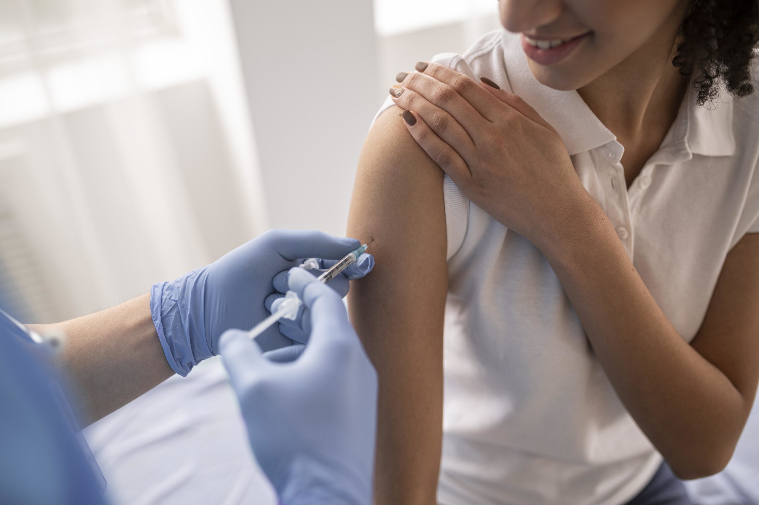 doctor-vaccinating-patient-clinic doctor-vaccinating-patient-clinic